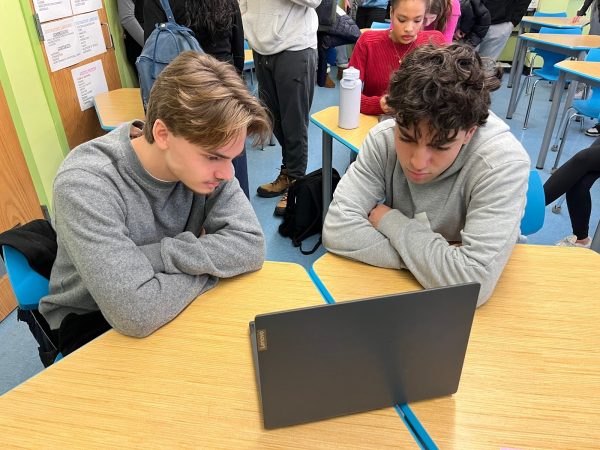 Seniors Quinn Baudenbacher and Elyes Bouchik reacting to delays in the FAFSA.
