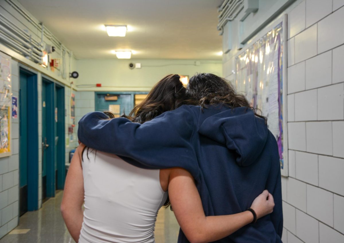 Juniors Stella Schweitzer and Delia Nakatani embracing each other in a time of distress