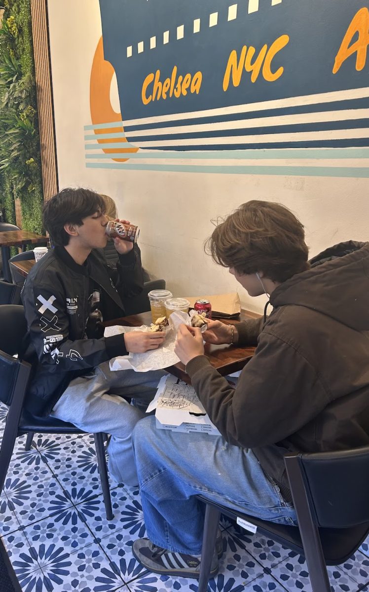 Juniors Michael Rodriguez and Vero Lambert eating at Ark Bagels despite the small sizes