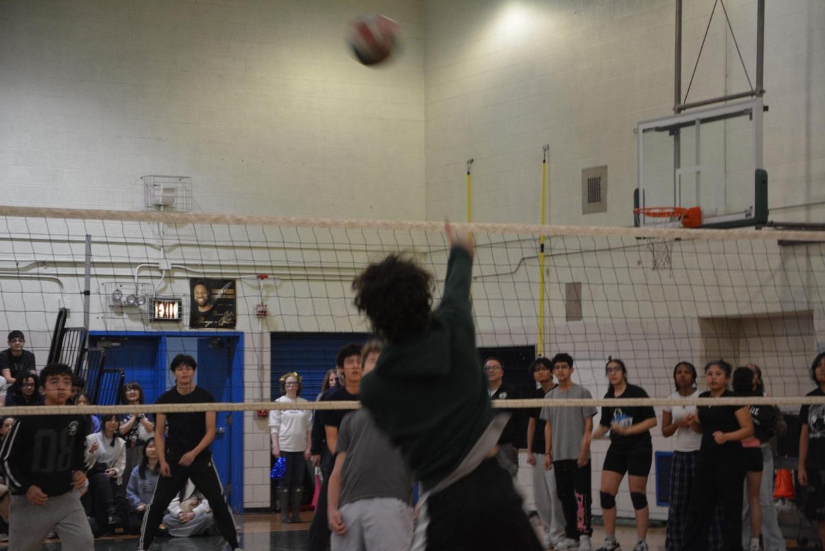 Baron Diaz, a senior, hits the ball over the net in the Sophomore vs. Seniors match.