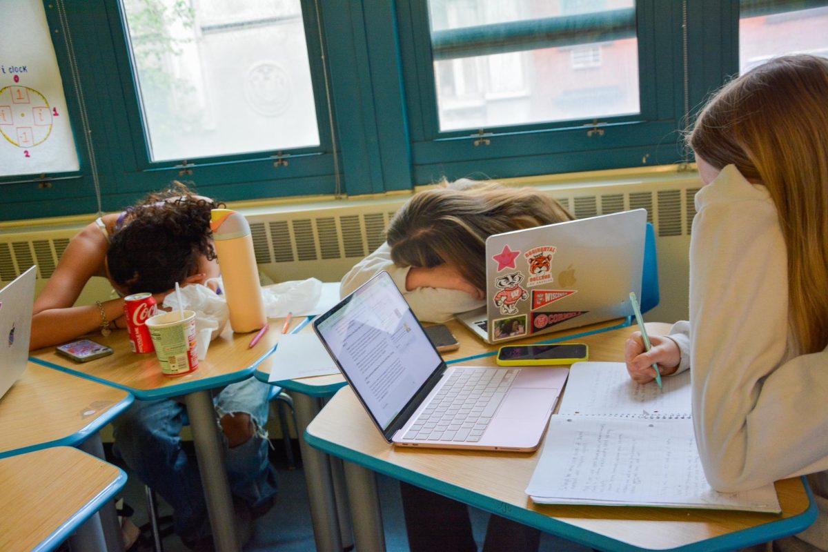 Student at work while their peers sleep at their desk