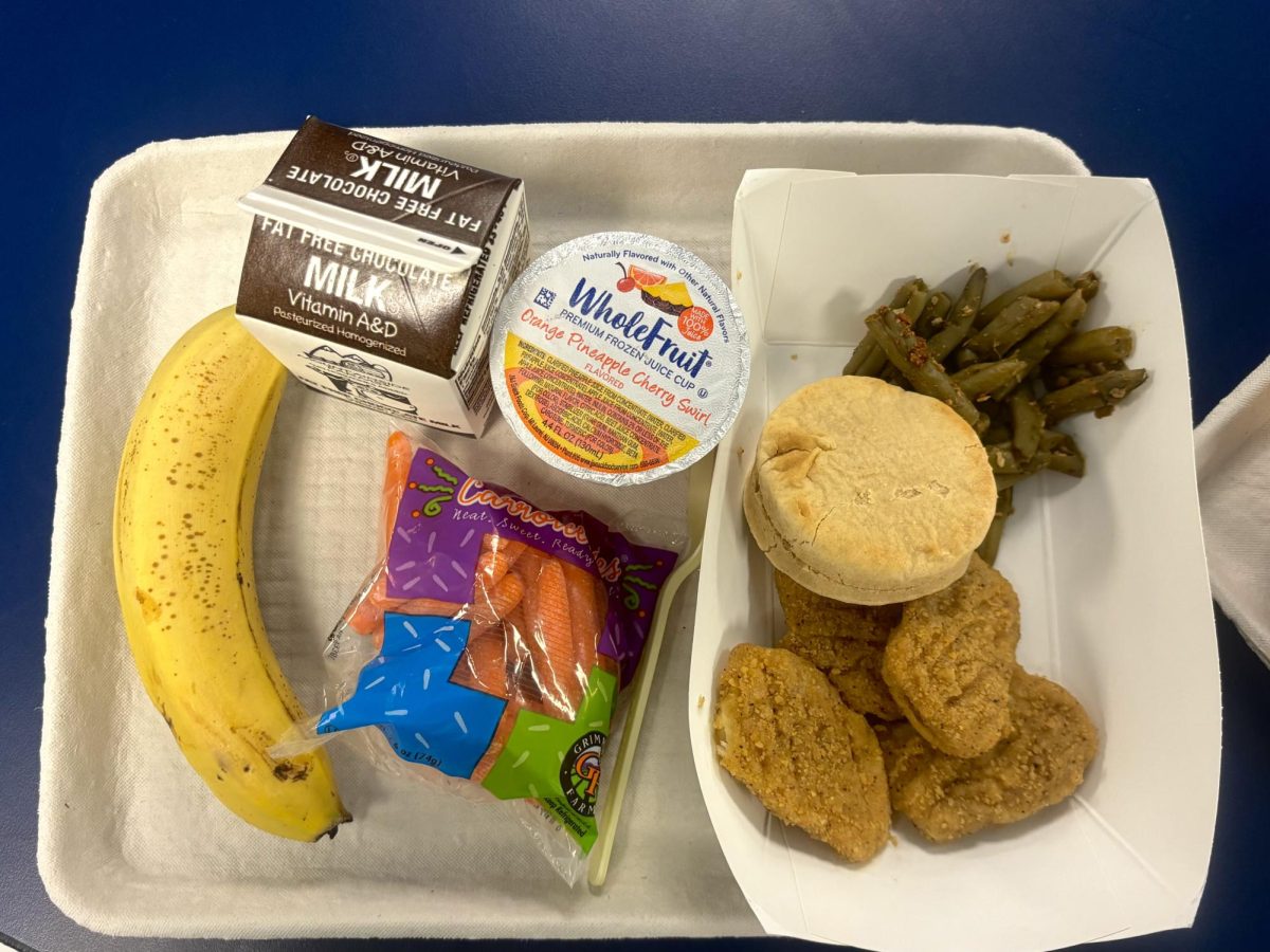A colorful meal including fresh fruit, vegetables, protein, and milk all served in the cafeteria